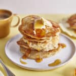 A stack of fluffy vegan pancakes with banana