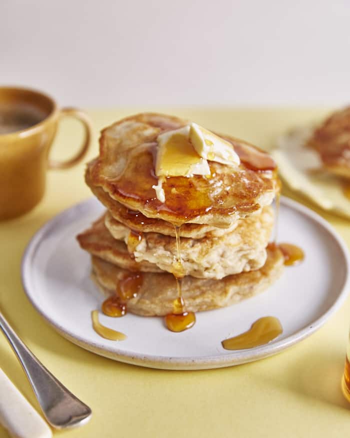A stack of fluffy vegan pancakes with banana